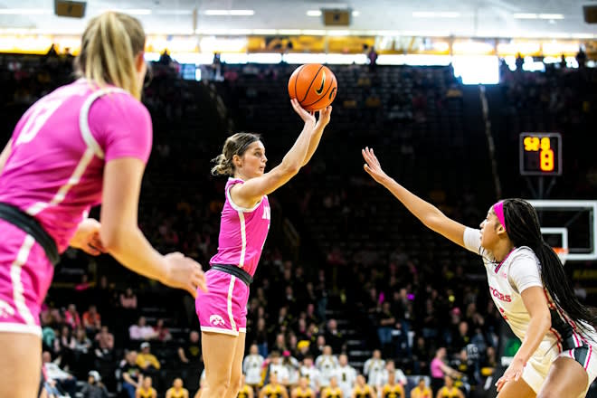 Iowa guard Taylor McCabe, center, makes a basket as Rutgers center Kassondra Brown (22) during a NCAA Big Ten Conference women's basketball game, Sunday, Feb. 12, 2023, at Carver-Hawkeye Arena in Iowa City, Iowa. 