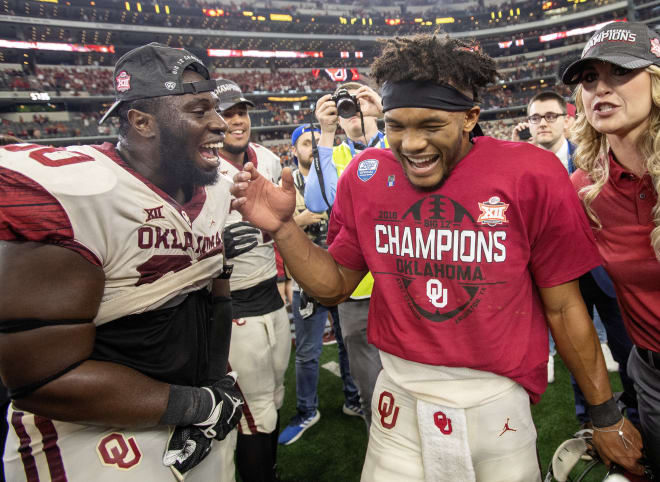 Oklahoma QB Kyler Murray, right, celebrates with teammate Neville Gallimore.