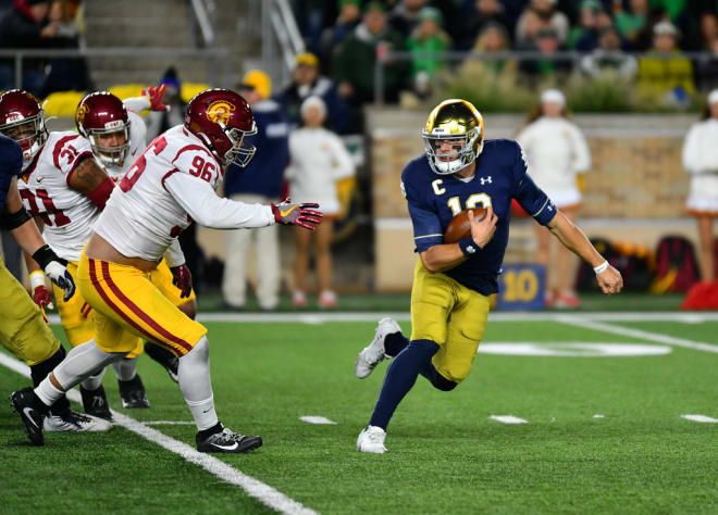 Notre Dame quarterback Ian Book running the ball against USC (Andris Visockis)