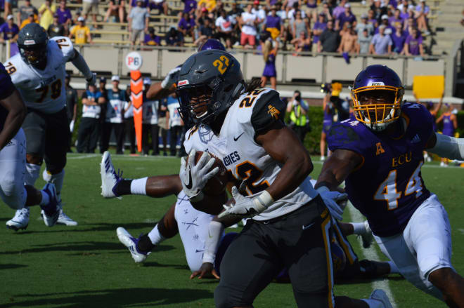 Aggie running back Marquell Cartwright turns the corner on ECU defensive end Kendall Futrell in Sunday's A&T win.