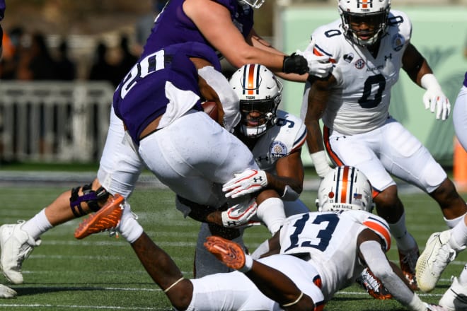 McClain makes a tackle with Pappoe and Ladarius Tennison in support.