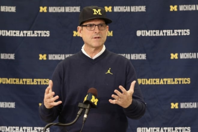 Michigan Wolverines head football coach Jim Harbaugh and his team have paused in-person team activities for the time being.