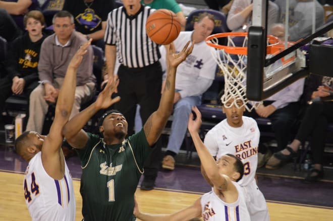 South Florida's Chris Perry battles in the paint against East Carolina's Kanu Aja and Grant Bryant.