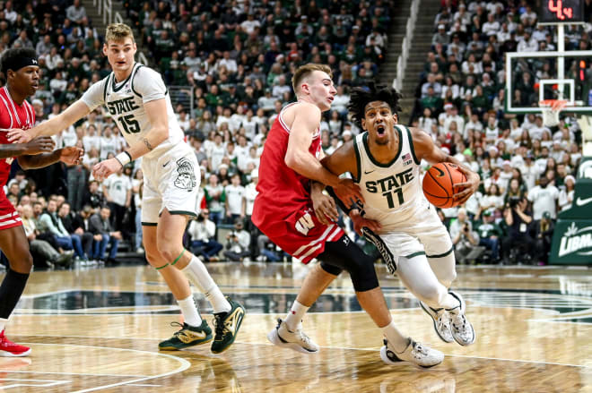 Michigan State's A.J. Hoggard, right, is fouled by Wisconsin's Tyler Wahl during the first half on Tuesday, Dec. 5, 2023, at the Breslin Center in East Lansing.