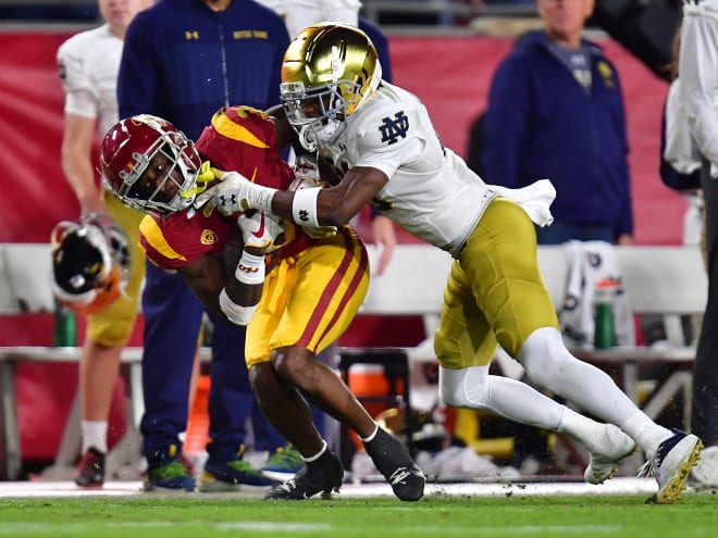 Freshman cornerback Benjamin Morrison (right) tackles USC standout wide receiver Jordan Addison (left). 