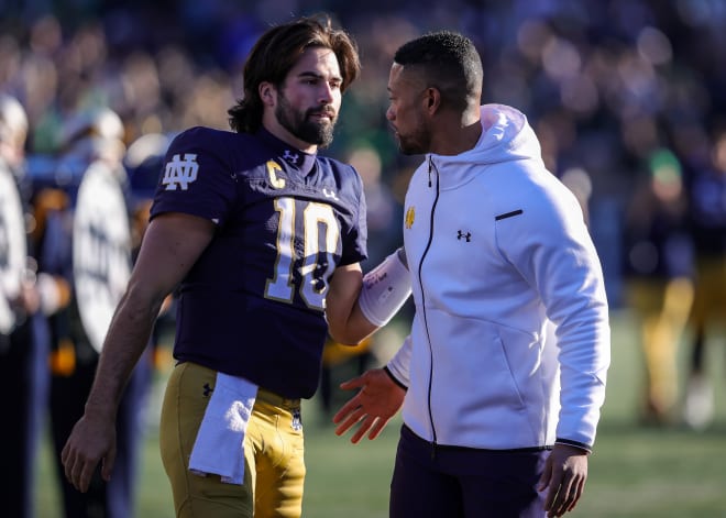 Notre Dame quarterback Sam Hartman (left) won't be joining coach Marcus Freeman and the Irish in their Sun Bowl matchup with Oregon State.