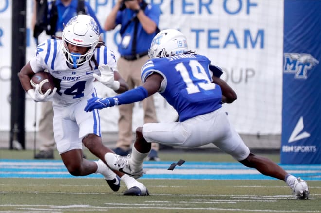 Duke's Que'Sean Brown, left, tries to avoid a tackle attempt of Middle Tennessee's Kellen Stewart on Saturday. 