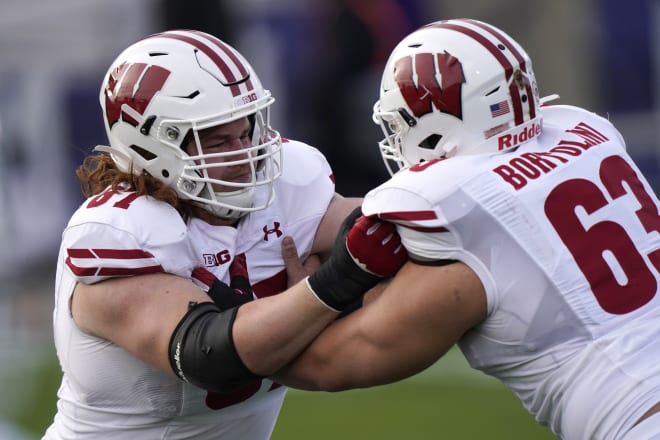 Wisconsin offensive line Jon Dietzen, left, warms up with Tanor Bortolini before an NCAA college football game against Northwestern