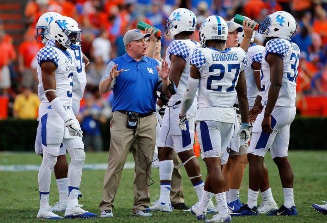 Mark Stoops met with his defense during a break in the action from last year's Kentucky game at Florida. 