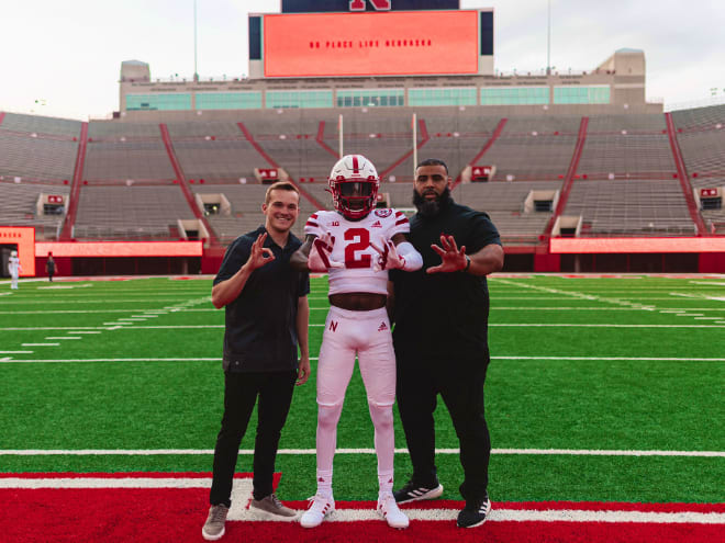 Left to right: Nebraska WR coach Garret McGuire, Jacory Barney Jr. and Husker assistant Phil Simpson.