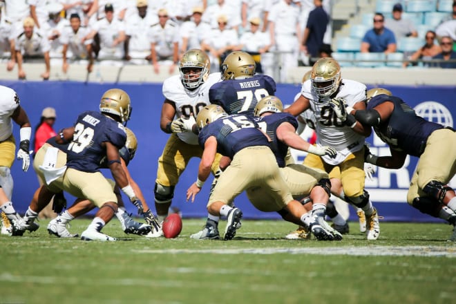 A Navy player jumping on a lose ball in the 2016 matchup against Notre Dame, the last time the Irish lost to the Mids (Blue and Gold Illustrated Photo)