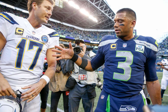 Pack Pros Philip Rivers and Russell Wilson shake hands after a game between the Chargers and Seahawks