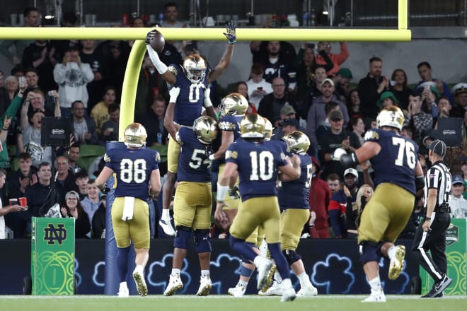 Notre Dame wide receiver Deion Colzie (0) celebrates a touchdown with his teammates in ND's 42-3 rout of Navy Saturday in Dublin, Ireland.