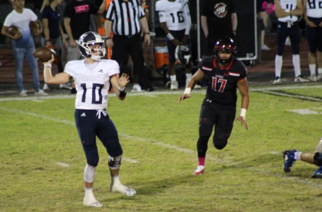 Pinnacle quarterback JD Johnson surveys the field and gets ready to deliver a pass in Friday's game at Liberty.  Johnson completed 15-of-25 passes for a season-best 324 yards.  It was also the third time this season he has thrown four touchdowns in a game.