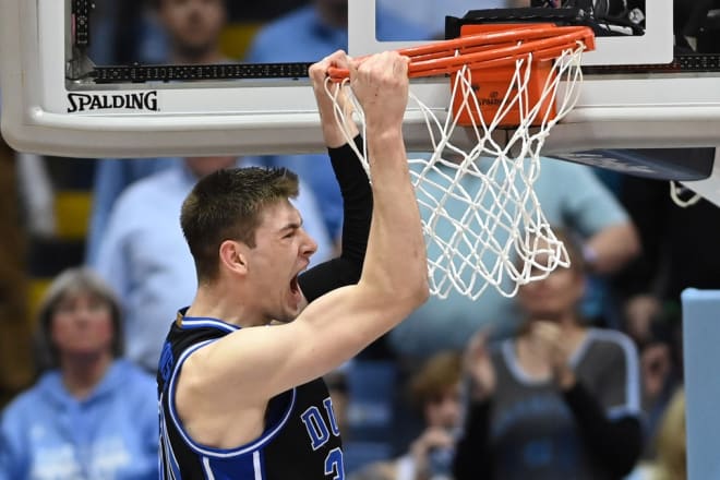 Duke freshman Kyle Filipowski dunks against UNC during Saturday night's game. 