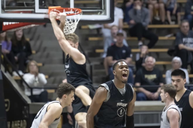 Purdue's Caleb Furst dunks off an assist from Brandon Newman