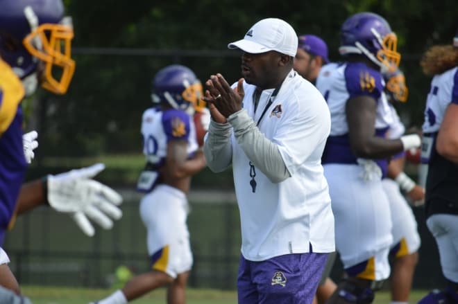 East Carolina head football coach Scottie Montgomery spurs on his team Wednesday morning.