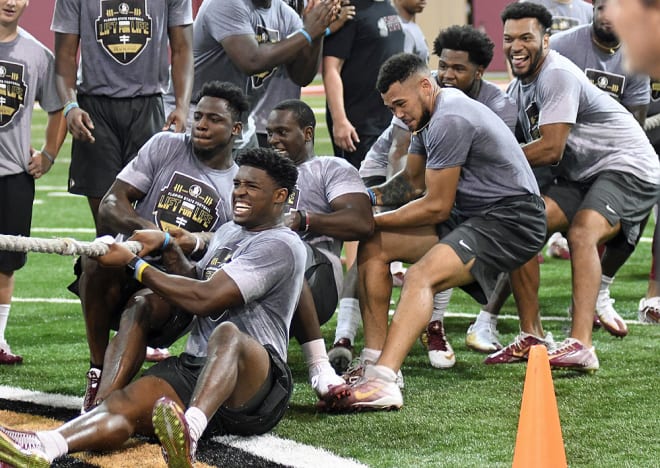 Defensive end Joshua Kaindoh (bottom) and other Florida State football players compete in the tug of war during a previous Lift for Life event.