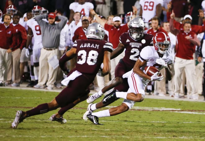 Alabama freshman receiver DeVonta Smith (6) races past Mississippi State defenders for the game-winning touchdown Saturday. Photo | Getty Images. 