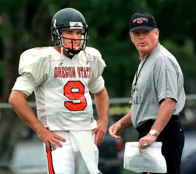 Oregon State head football coach Dennis Erickson talks strategy with quarterback Jonathan Smith during practice in Corvallis, Ore., Wednesday, Aug. 18, 1999