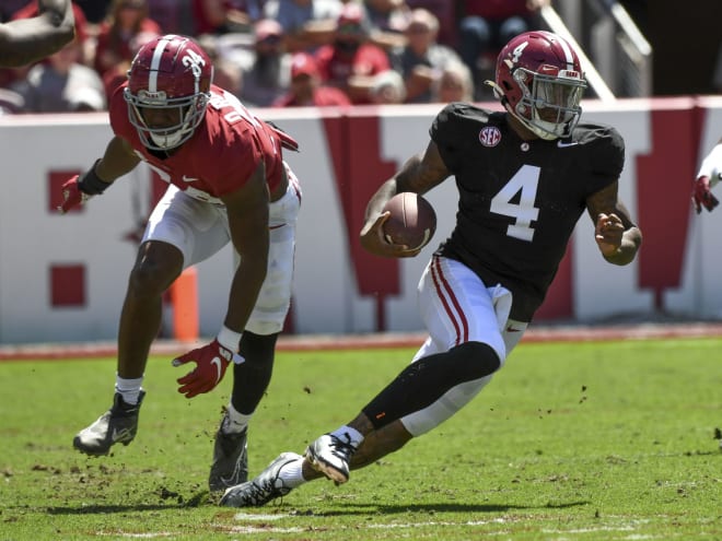 Crimson team linebacker Quandarrius Robinson (34) can t stop a run by White team quarterback Jalen Milroe (4) during the A-Day game at Bryant-Denny Stadium. Photo | Gary Cosby-USA TODAY Sports
