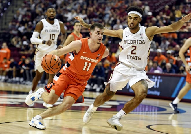 FSU's Anthony Polite tries to guard Syracuse's Joseph Girard III during the teams' game in December.