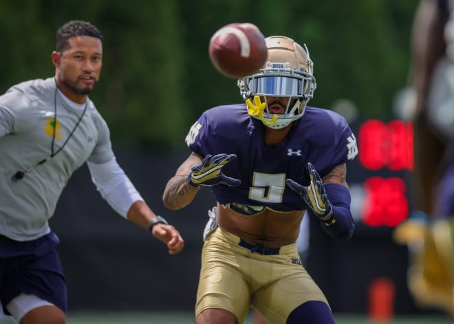Notre Dame head coach Marcus Freeman looks on as wide receiver Joe Wilkins Jr. tracks a pass at a recent Irish football practice.