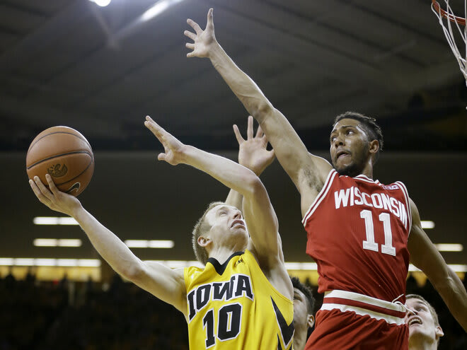 Wisconsin guard Jordan Hill, right, tries to block a shot by Iowa guard Mike Gesell in 2016. Wisconsin won that night for a third straight time in Iowa City.