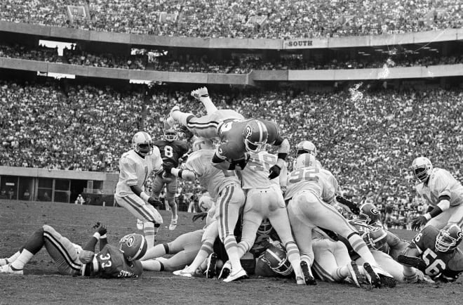 Herschel Walker dives over a pile of Tennessee defensemen in 1981.