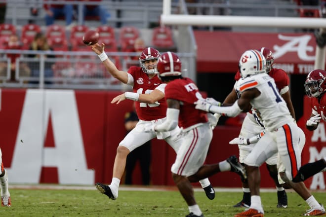 Alabama Crimson Tide quarterback Mac Jones delivers a pass during Saturday's Iron Bowl game against Auburn. Photo | Getty Images