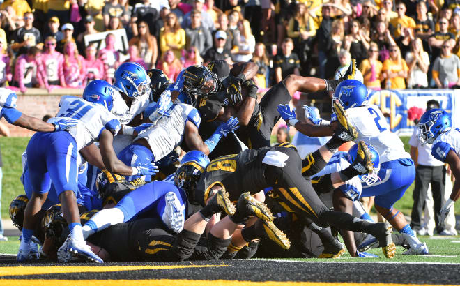 The Blue Raiders and Tigers clash on the goal line in the early goings of Saturday's matchup.