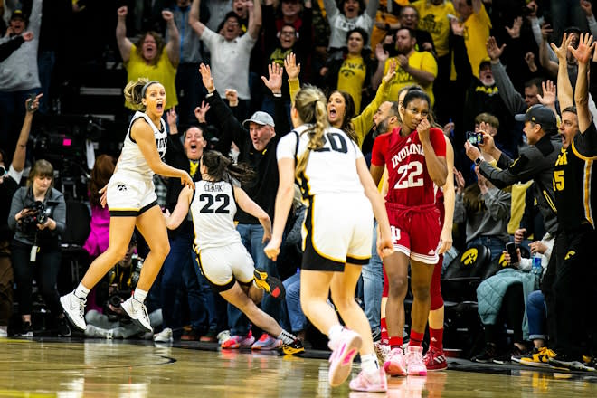 Iowa guards Gabbie Marshall, left, and Kate Martin celebrate the 3-point basket from teammate Caitlin Clark as Indiana guard Chloe Moore-McNeil, right, walks off the court after a NCAA Big Ten Conference women's basketball game, Sunday, Feb. 26, 2023, at Carver-Hawkeye Arena in Iowa City, Iowa.