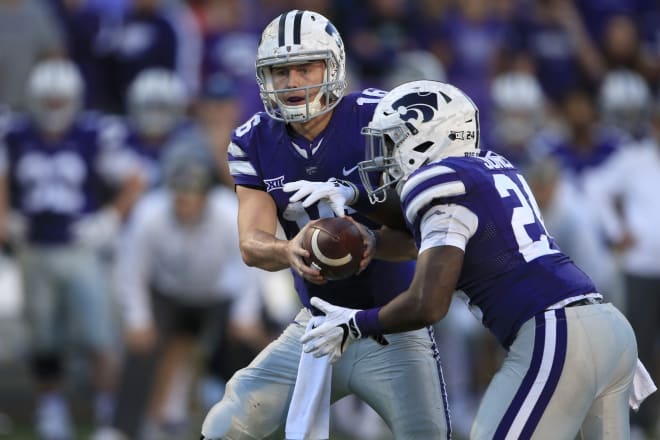 Jesse Ertz threw for less than 100 yards, but ran for three touchdowns in the white camo helmet