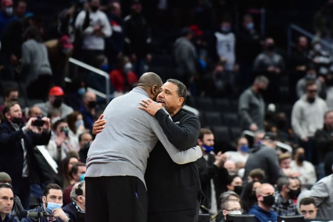 Ed Cooley, here hugging former G'Town HC Pat Ewing, has been hired as his successor. 