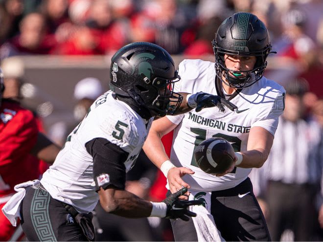 Michigan State quarterback Katin Houser (12) hands there ball off to running back Nathan Carter (5) versus Indiana on Nov. 18, 2023.