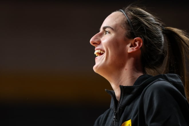 Caitlin Clark smiles during warmups against Minnesota before breaking the major-college scoring record Wednesday.