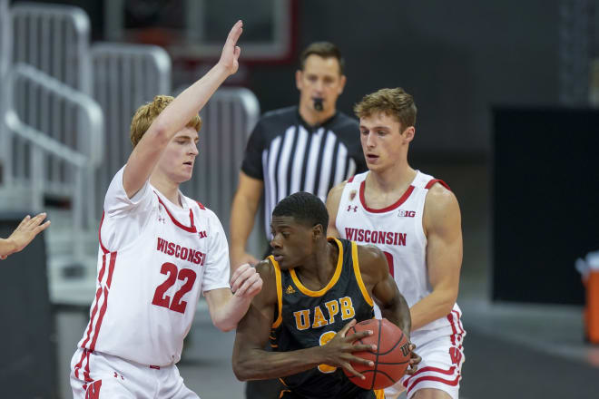 Wisconsin's Steven Crowl (22) and Ben Carlson (20) trap Arkansas-Pine Bluff's Markedric Bell (3) during the second half. Wisconsin won 92-58.