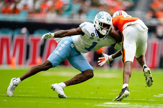 North Carolina Tar Heels defensive back Tony Grimes (1) tackles Miami Hurricanes wide receiver Frank Ladson Jr. (8) during the first half at Hard Rock Stadium. Photo | Rich Storry-USA TODAY Sports