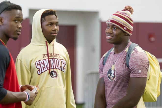 FSU commitments Amari Gainer (left) and Charles Strong (right) talk with recruit Isaiah Bolden.