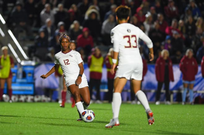 FSU senior Kaycie Tillman looks to pass the ball to freshman Yujie Zhao during the Seminoles' NCAA semifinal victory over Stanford.