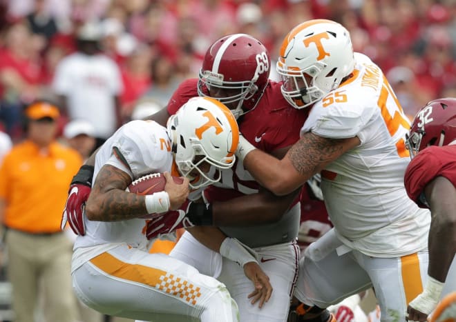 Tennessee Volunteers offensive lineman Coleman Thomas (55) attempts to stop Alabama Crimson Tide defensive lineman Joshua Frazier (69) from grabbing Volunteers quarterback Jarrett Guarantano (2) during the second quarter at Bryant-Denny Stadium. Photo | USA Today