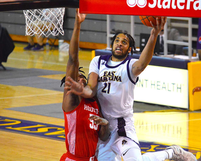 ECU's Ludgy Debaut drives for one of two  baskets that helped set the tone early in the Pirates' win over (5)Houston.