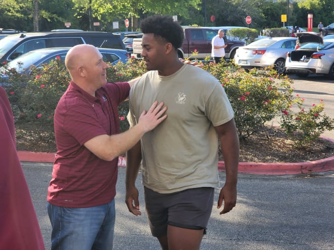 FSU defensive coordinator Adam Fuller greets defensive tackle Xzavier McLeod.