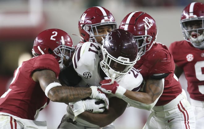 Alabama defensive back Patrick Surtain II (2), Alabama defensive back Brian Branch (14) and Alabama defensive back Malachi Moore (13) combine to tackle Mississippi State running back Jo'quavious Marks (21) at Bryant-Denny Stadium during the second half of Alabama's 41-0 win over Mississippi State. Photo | Imagn