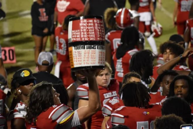 Tight end Camp Magee hoists the Barrel trophy after Edgewater's 21-14 win over Boone.