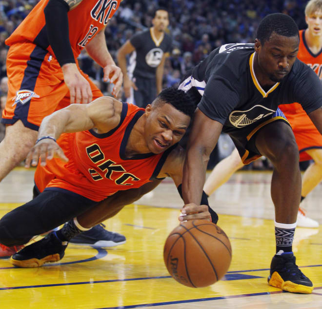 Oklahoma City Thunder guard Russell Westbrook battles for a loose ball with Golden State's Harrison Barnes Saturday night. Barnes' Warriors won, 116-108, in a game many believe is a preview of the Western Conference Finals.