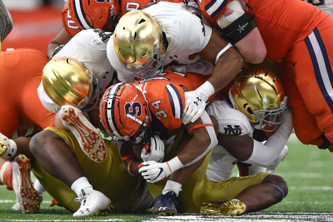 The Notre Dame defense swarms Syracuse running back Sean Tucker Saturday during a 41-24 Irish road victory.