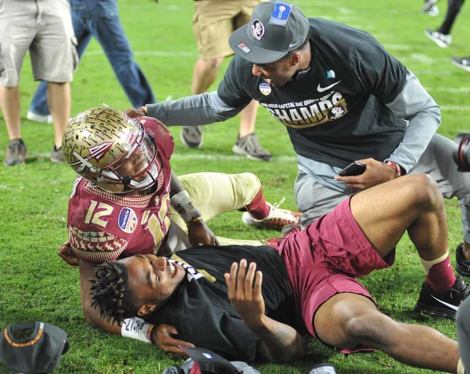 Derwin James and George Campbell tackle Deondre Francois after the game in celebration.