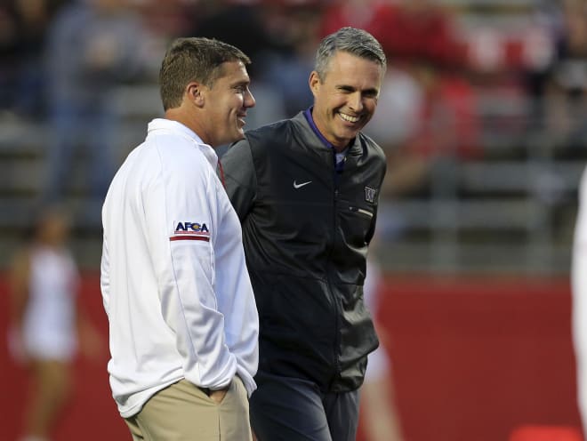 Rutgers head coach Chris Ash, left, and Washington head coach Chris Petersen stand together on the field before an NCAA college football game Friday, Sept. 1, 2017, in Piscataway, N.J. (AP Photo/Mel Evans)