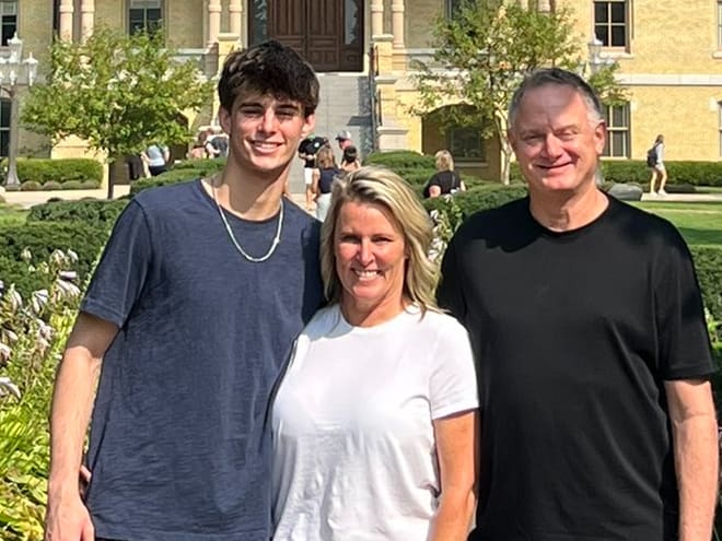 Three-star shooting guard Brady Dunlap, left, poses with his mother, DeeDee, and father, Jeff, during his visit to Notre Dame.